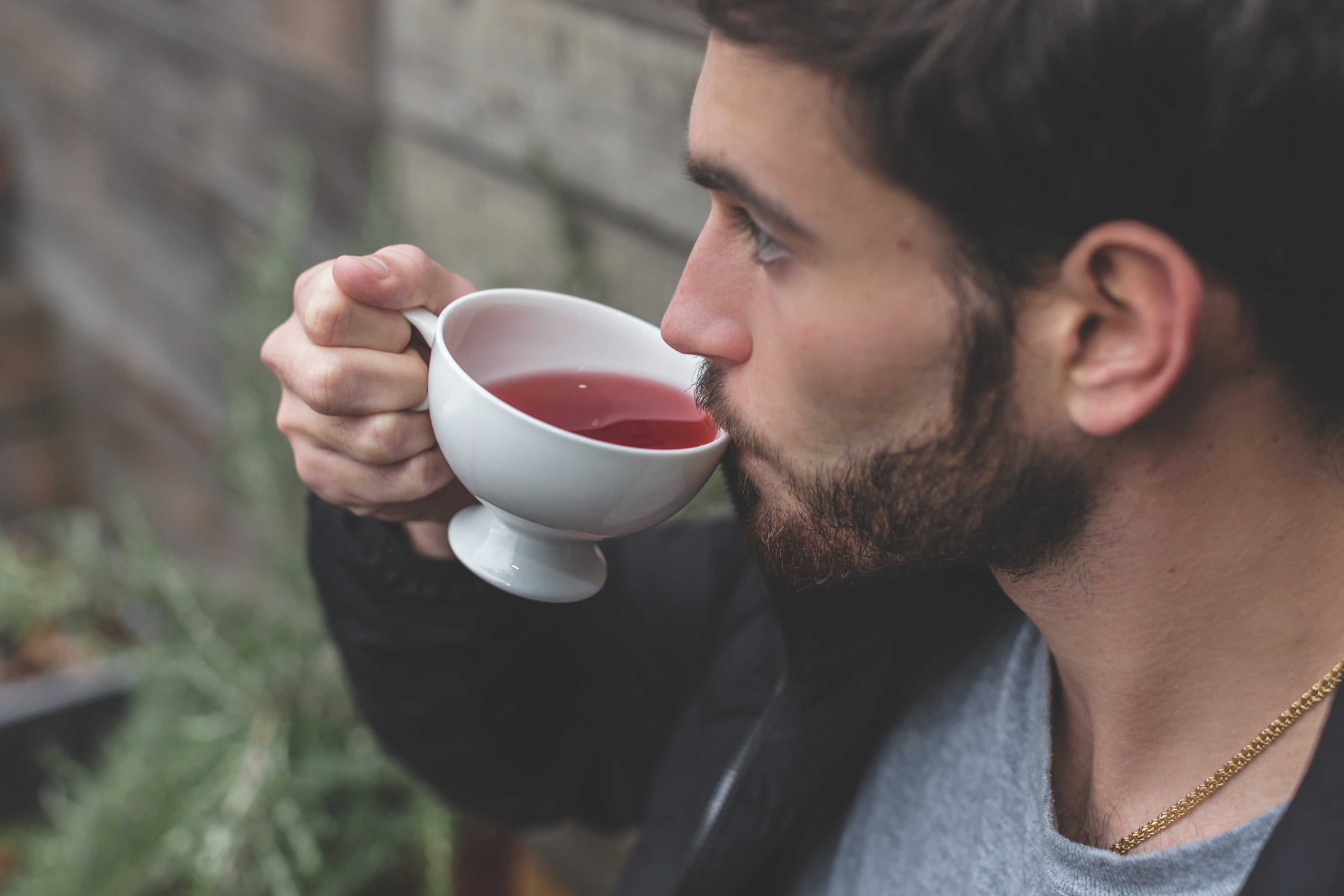 A man is sipping a herbal tea